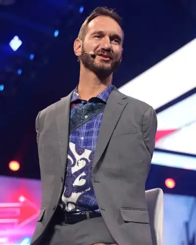 Nick Vujicic, motivational speaker, smiling on stage