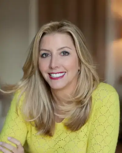 Sara Blakely, founder of Spanx, smiling at an event